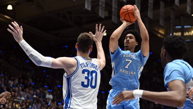 Mar 9, 2024; Durham, North Carolina, USA; North Carolina Tar Heels guard Seth Trimble (7) shoots over Duke Blue Devils center Kyle Filipowski (30) during the first half at Cameron Indoor Stadium.